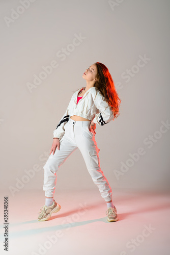 Fototapeta Naklejka Na Ścianę i Meble -  Young beautiful dancer posing on a studio background