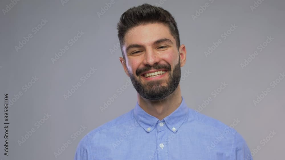 people concept - video portrait of happy smiling young man with beard over grey background people concept - video portrait of happy smiling young man with beard over grey background