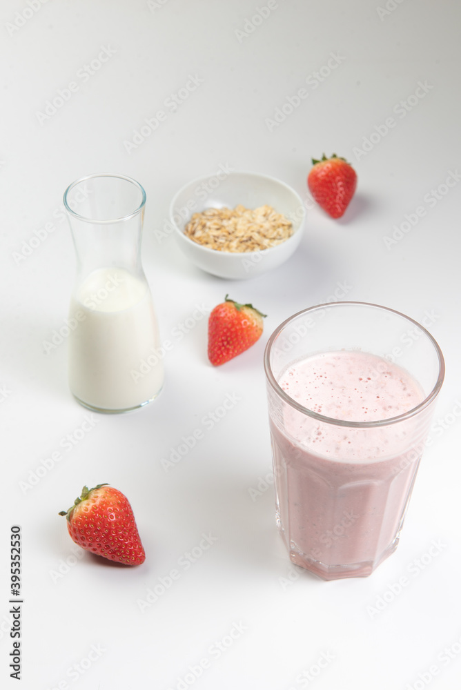  strawberry cereal cocktail for breakfast in a glass cup on a white plate with ingredients. shooting from top to bottom. flat composition. with free space for text, labels and logos