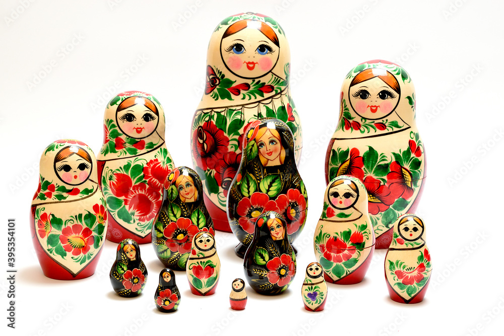 Two multi-colored sets of Russian nesting dolls lined up across the entire plane of the image. Two multi-colored sets of Russian nesting dolls lined up across the entire plane of the image.
