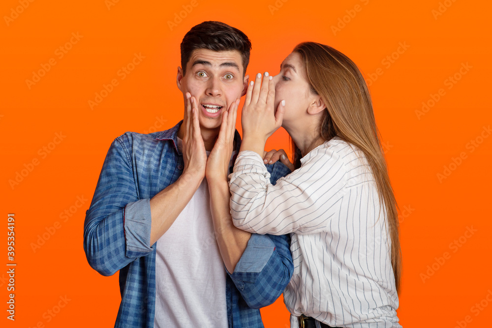 Millennial lady tells in ear to surprised guy something amazing, funny male do not believe it Millennial lady tells in ear to surprised guy something amazing, funny male do not believe it