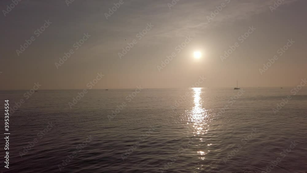Sun glare, sunny path, small waves with white foam. Amazing sunset. Dramatic sky Sun glare, sunny path, small waves with white foam. Amazing sunset. Dramatic sky