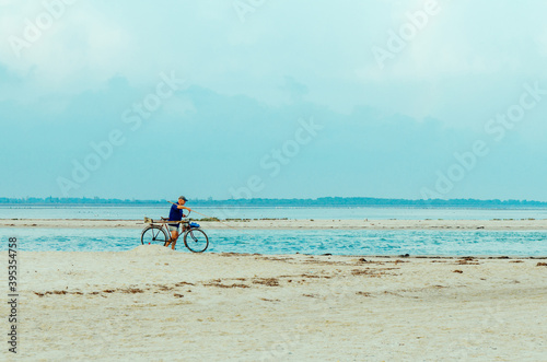 person riding a bike on the beach