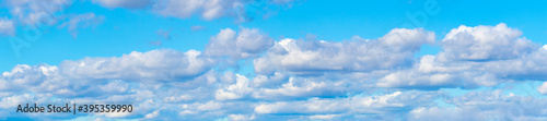 Panorama of blue sky with white volumetric clouds