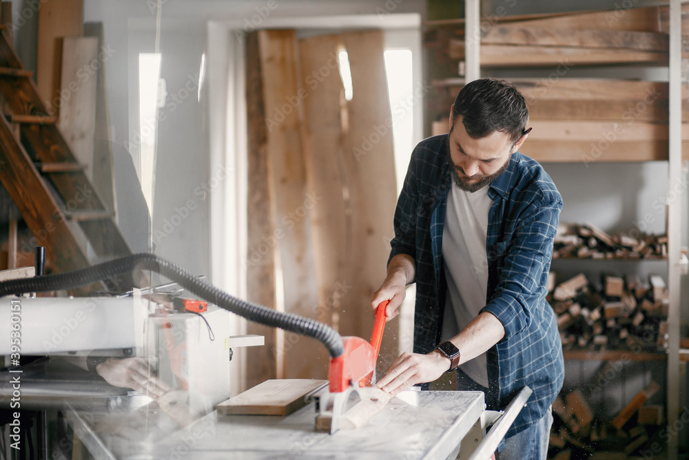 Wood cutting with circular saw. Closeup of mature man sawing lumber. Wood cutting with circular saw. Closeup of mature man sawing lumber.