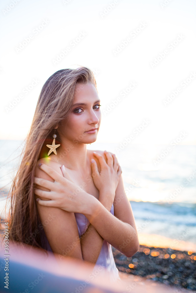 mermaid myth in sunset on beach shore with fish star shells pearls earrings jewelry