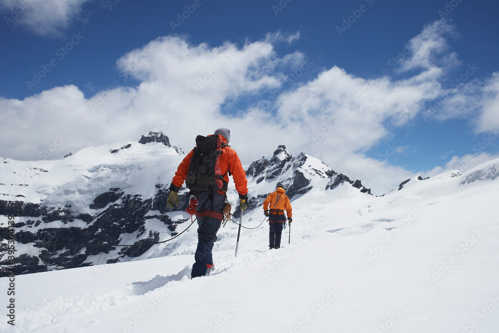Hikers Joined By Safety Line In Snowy Mountains