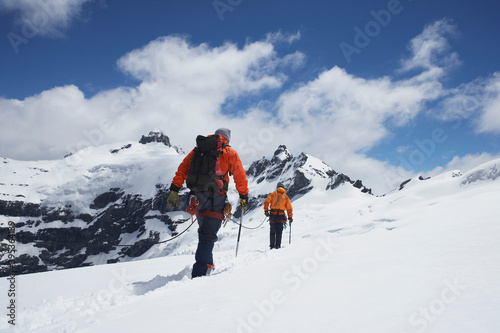 Hikers Joined By Safety Line In Snowy Mountains