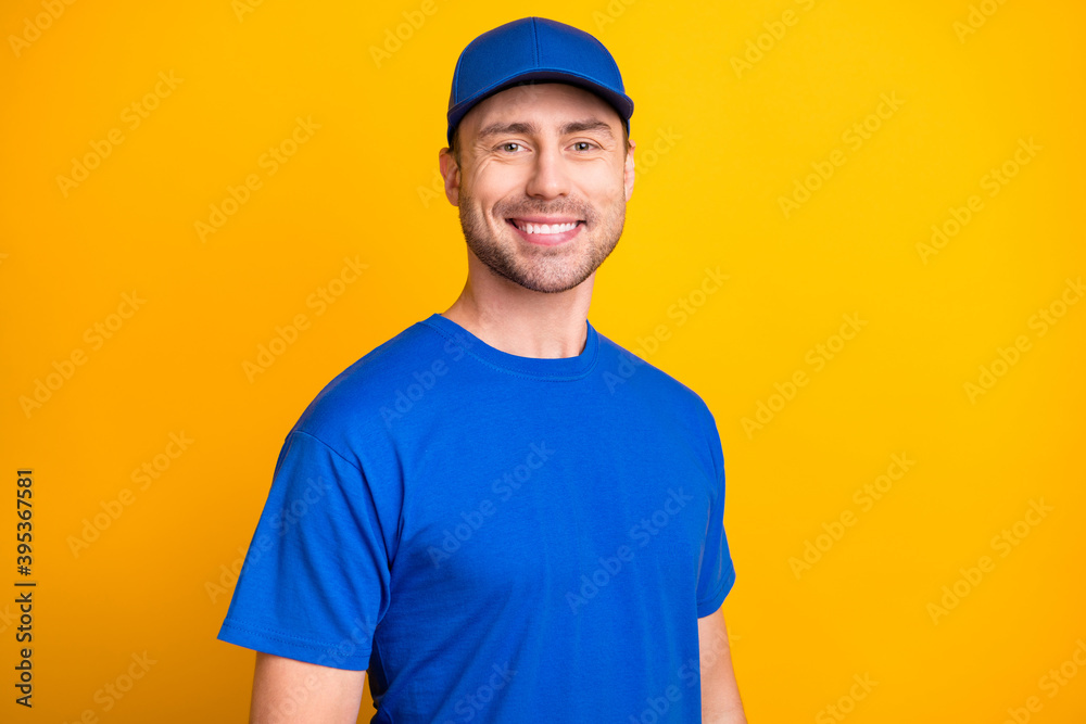 Portrait of half turned handsome working person smile headwear isolated on vibrant yellow color background