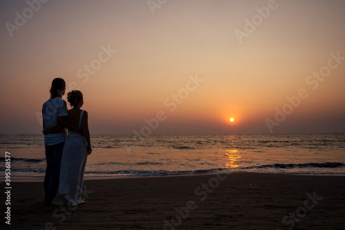 Justmarried couple running on a sandy beach