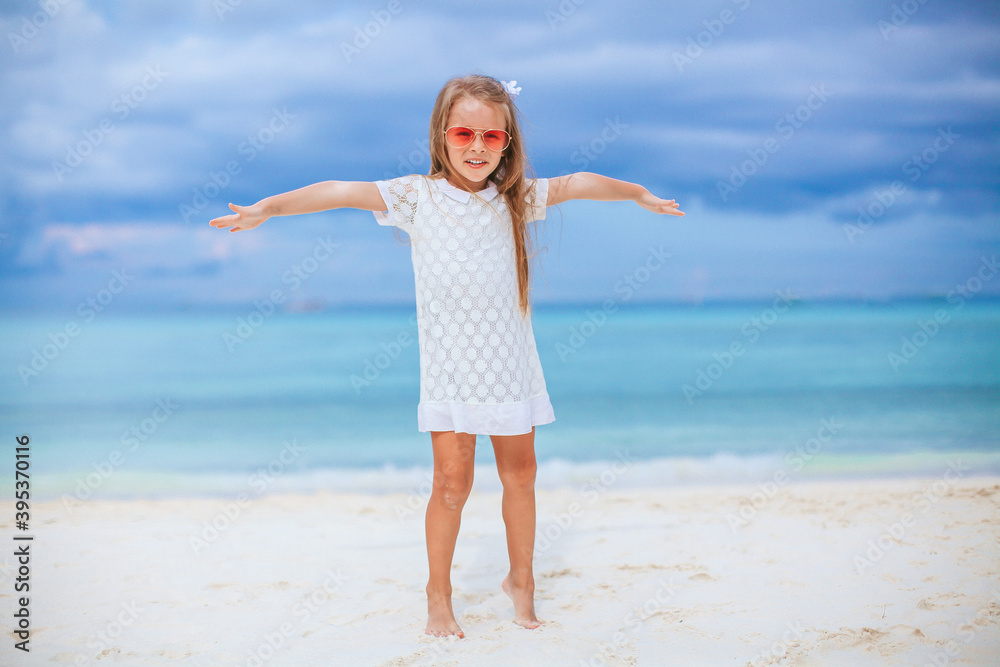Adorable little girl at beach on her summer vacation Adorable little girl at beach on her summer vacation