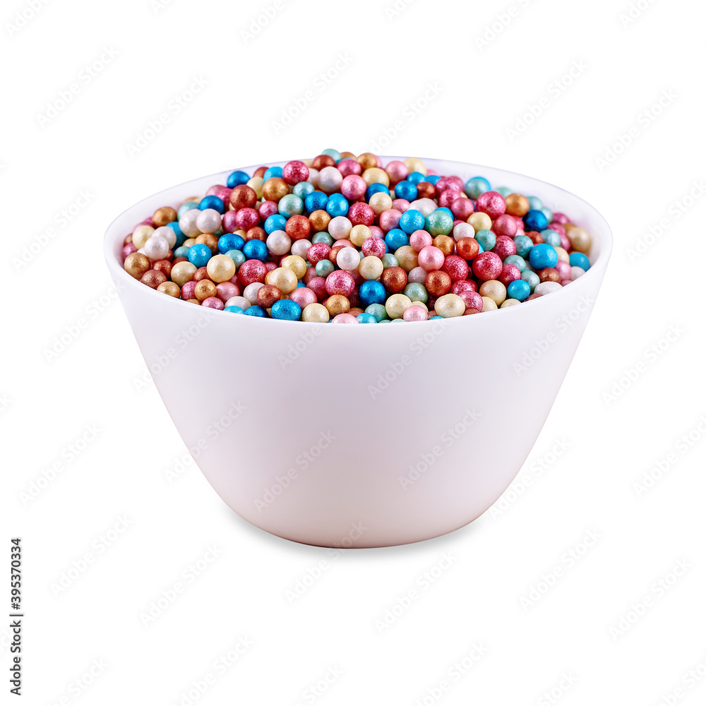 Colorful sugar dragee in white bowl isolated on white background, copy space.