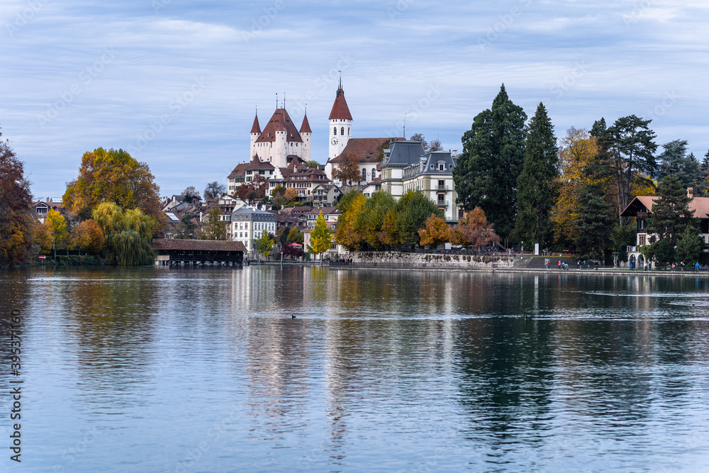 Thun medieval old town reflecting in the water of the Aar river in Switzerland