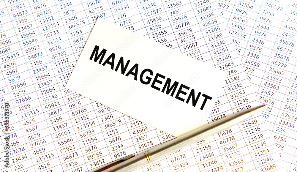 Fototapeta premium On the vcard is the MANAGEMENT text, next to reports and a pen.