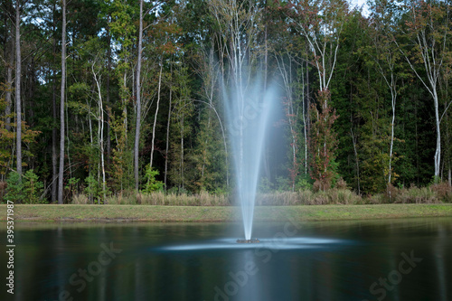 fountain in park - water sprayed into the air creates a plume-like effect and long exposure gives it a silky look.