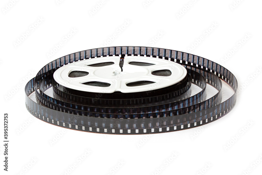 8mm film reel with film strips scattered around. Close-up image isolated on white background.