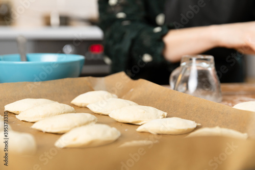 Women preparing homemade food pie, pizza in a cozzy kitchen. Hobbies and family life concept. photo