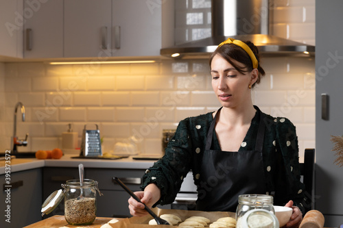 Women preparing homemade food pie, pizza in a cozzy kitchen. Hobbies and family life concept. photo