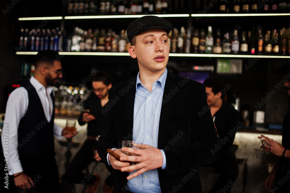 Stylish arab man against group of handsome retro well-dressed guys gangsters spend time at club, drinking on bar counter. Multiethnic male bachelor mafia party in restaurant. Stylish arab man against group of handsome retro well-dressed guys gangsters spend time at club, drinking on bar counter. Multiethnic male bachelor mafia party in restaurant.