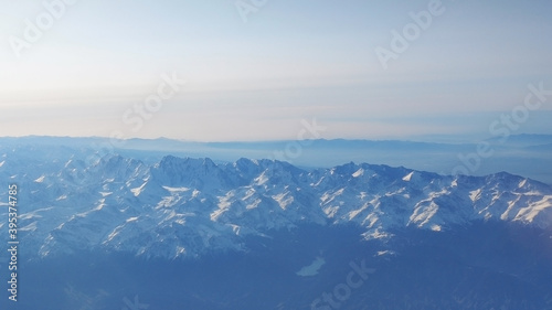 View of the snow covered mountains from the plane. Ile-Alatau National Park. Kazakhstan