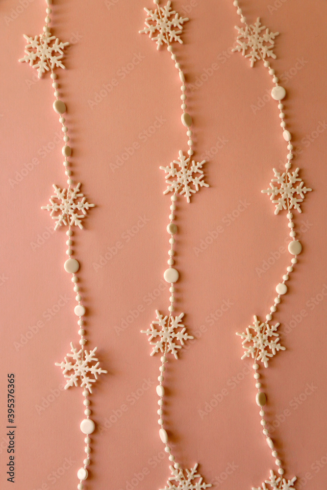 Snowflake garland on pink background. Top view. Snowflake garland on pink background. Top view.