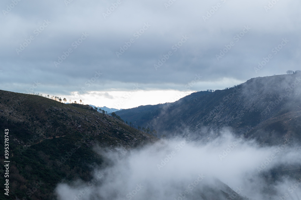 Sunrise in the mountains. Cloudy sky and low clouds. Peneda-Gerês National Park.