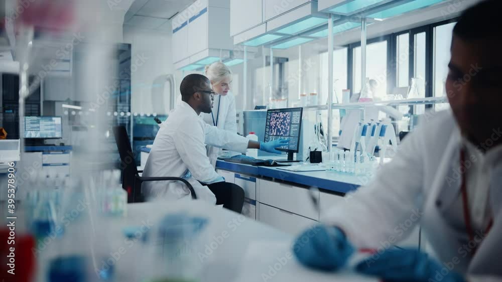 Modern Medical Research Laboratory: Two Scientists Working Together Analysing Samples, Discussing Innovative Technology. Advanced Scientific Lab for Medicine, Biotechnology, Molecular Biology Modern Medical Research Laboratory: Two Scientists Working Together Analysing Samples, Discussing Innovative Technology. Advanced Scientific Lab for Medicine, Biotechnology, Molecular Biology