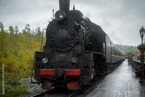 Old retro vintage steam train on platform station Ruskeala Park