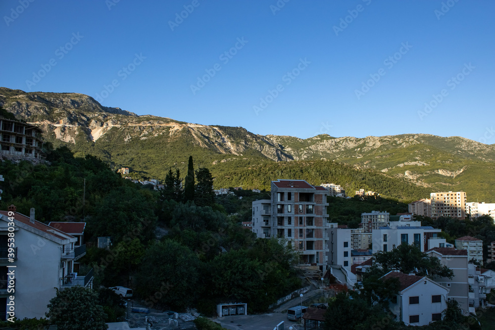 The mountain is covered with pine forest. Picturesque mountain landscape. City under the mountain. Montenegro, Europe, Balkans