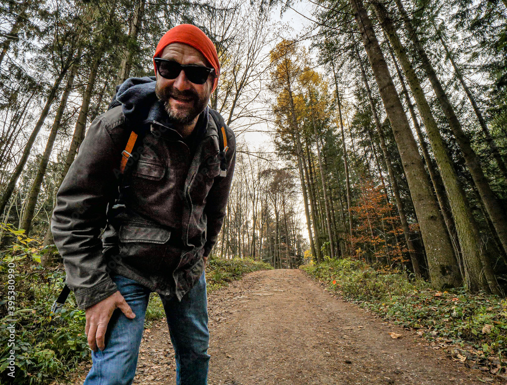 Young hiker explore the forest during autumn with a smile