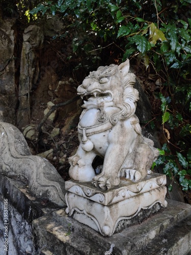 A marble Buddha sits outside of Linh Ung Pagoda near the top. Marble mountains park in da nang, vietnam