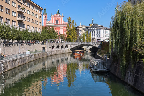 Ljubljana, Slovenia. View on Franciscan Church of the Annunciation and Triple Bridge across the Ljubljanica River. Latin motto on the Baroque facade of the church reads: Hail, full of grace!