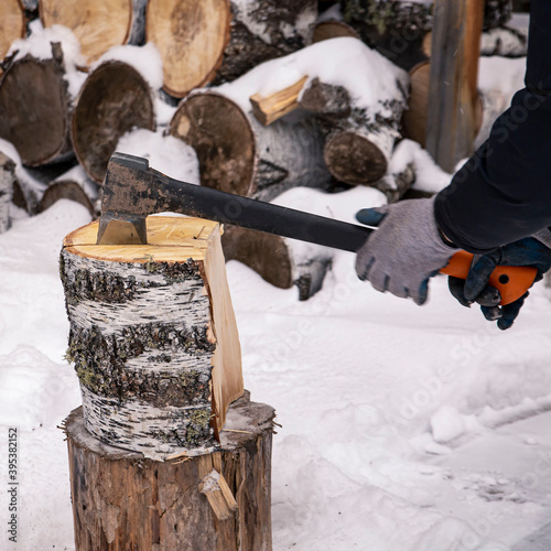 A man pricks birch wood with an ax. Work, tools, lifestyle.