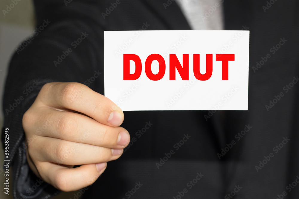 Card with text DONUT on hand. You can use in business, marketing and other concepts. Messege of the day. Card with text DONUT on hand. You can use in business, marketing and other concepts. Messege of the day.
