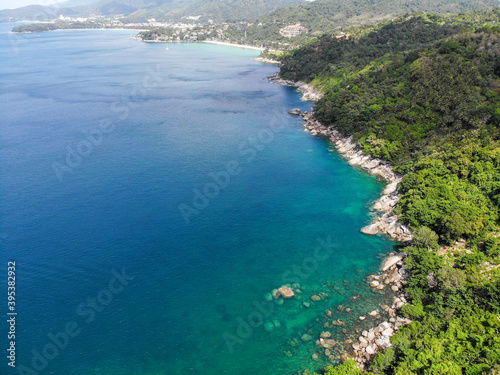 Top view aerial photo from flying drone of an amazing seascape with paradise beach and sea with turquoise water. Summer vacation holidays in Thailand. Perfect website background with copy space area.