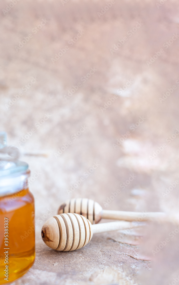 Glass can full of honey and wooden stick Glass can full of honey and wooden stick