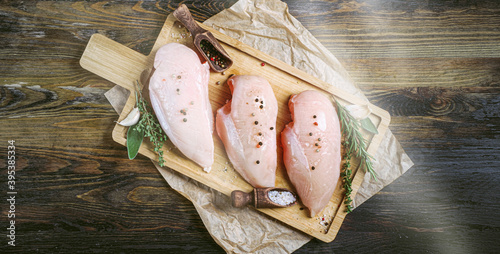 Billede på lærred fresh raw farm chicken fillet on a cutting board.