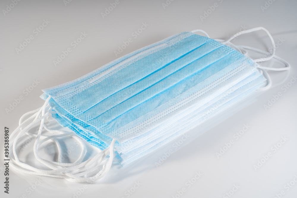 Stack of isposable blue white face mask on the side Stack of isposable blue white face mask on the side
