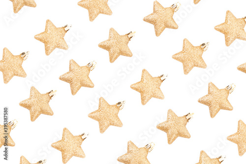 Top view of minimal golden and yellow Christmas elements pattern, stars glitter on white background for make creative design and paper print gift wrapping.