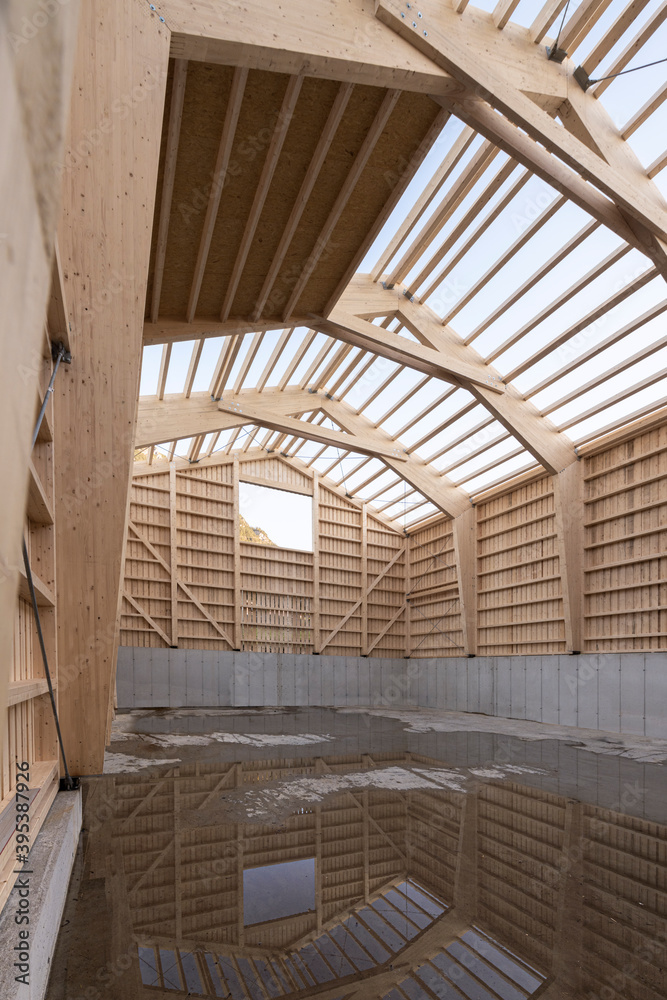 Obraz premium Construction of a hay shed with constructive timber construction and concrete with laminated beams