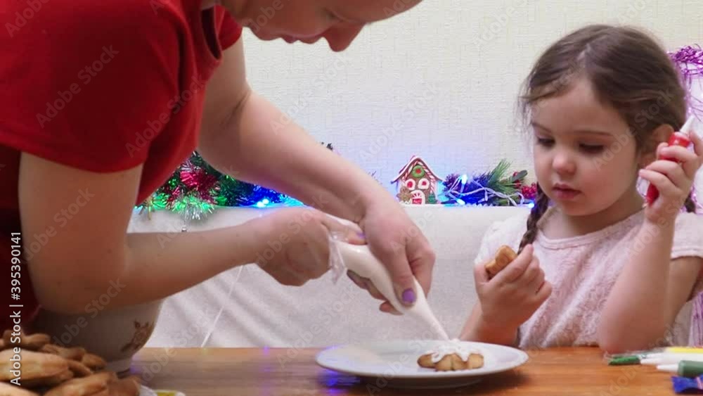 Merry Christmas and Happy Holidays. Family preparation holiday food. Mother and daughter cooking Christmas cookies. Merry Christmas and Happy Holidays. Family preparation holiday food. Mother and daughter cooking Christmas cookies.