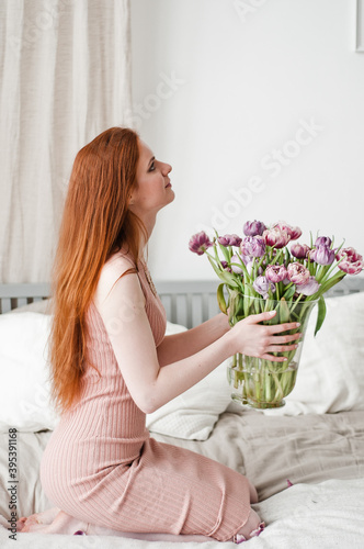 Boudoir Bride's morning. Cute red-haired girl in her happy day. red-haired girl with a bouquet of flowers.
