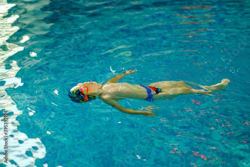 Картината върху платно Toddler swimming training in the pool