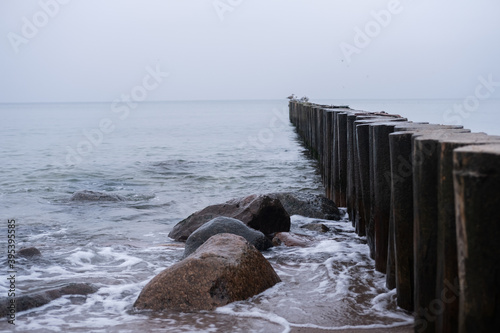 Obraz na płótnie breakwaters on the shores of the Baltic Sea on an autumn cloudy day w salonie