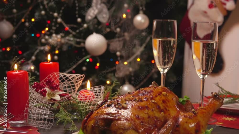 Panorama of the festive Christmas table setting with delicious baked chicken and glasses of champagne Panorama of the festive Christmas table setting with delicious baked chicken and glasses of champagne