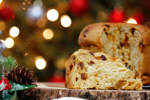 Panettone on a board with Merry Christmas tree and lights