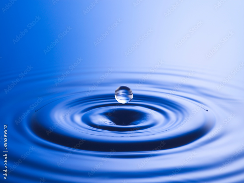 Drop hitting surface of water close-up Drop hitting surface of water close-up