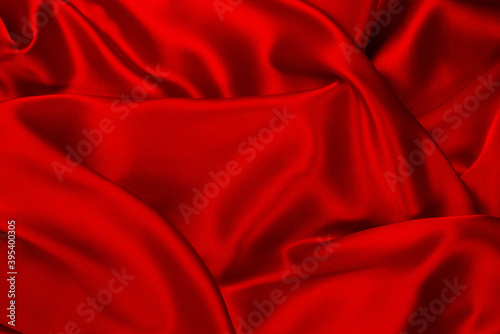 Red and orange silk or satin luxury fabric texture can use as abstract background.