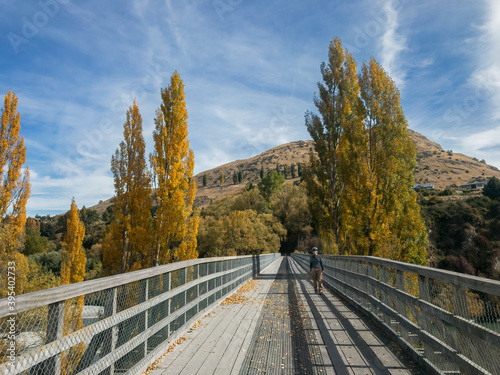 Biker walking on The Lower Shotover Bridge, Queenstown Area, South Island, New Zealand 