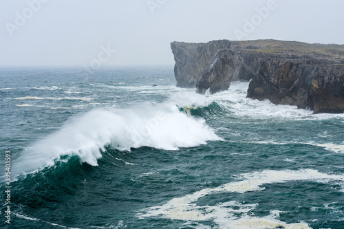 Landscape of the karst limestone sea cliffs in Asturias in the Llanes coast, North of Spain, with the waves cruhsing against the cliffs.